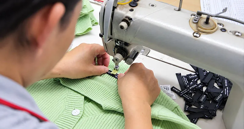 Applying brand logos and care labels to finished sweaters